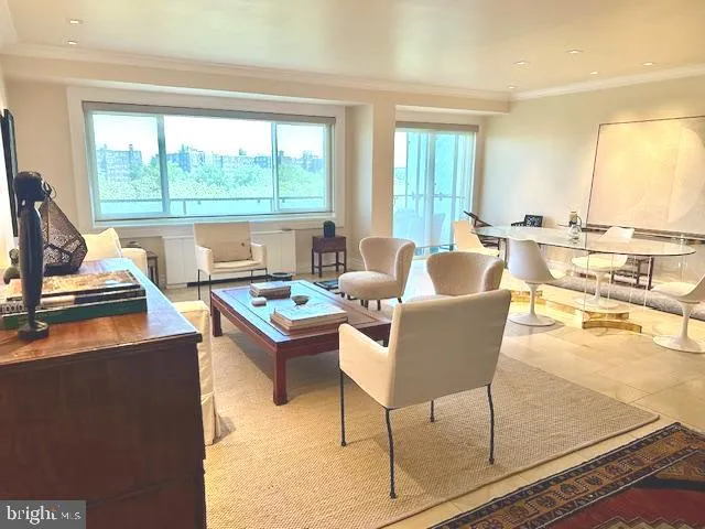 a living room with furniture and large windows