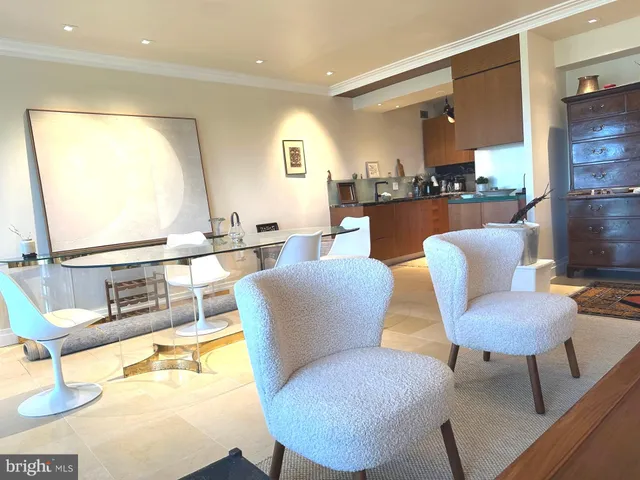 a dining room with furniture and a large window