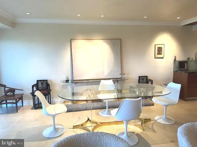 a dining room with furniture a large window and a wooden floor