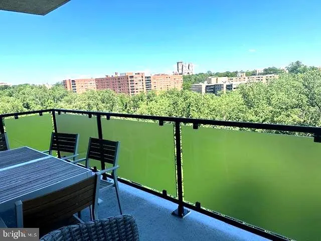 a view of a balcony with two chairs and a table
