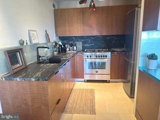 a kitchen with a stove and a refrigerator