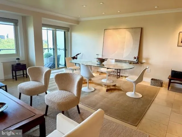 a dining room with couches a large mirror and a dining table with wooden floor