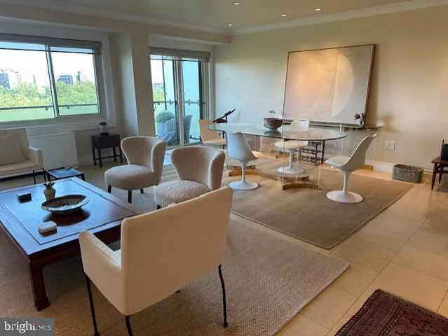 a dining room with couches a large mirror and a dining table with garden view