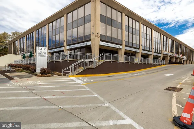 a view of a cafe with a table and chairs under an umbrella