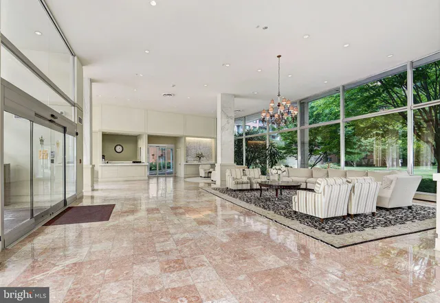 a living room with fireplace furniture and a chandelier