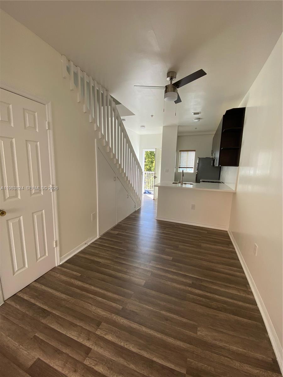 928 Southwest 3rd Street, Unit 203 Miami, FL 33130 - Photo 2 of 11 a view of a hallway with wooden floor and staircase