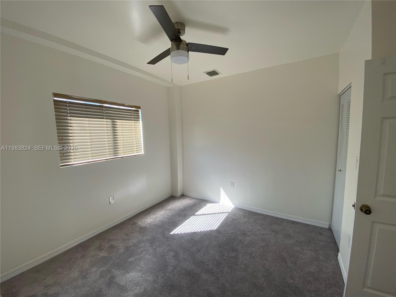 928 Southwest 3rd Street, Unit 203 Miami, FL 33130 - Photo 5 of 11 a view of a livingroom with a ceiling fan and window