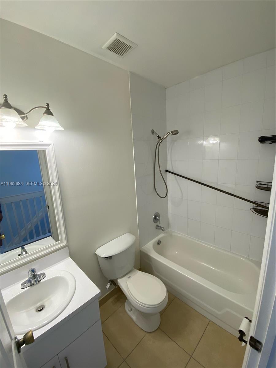 928 Southwest 3rd Street, Unit 203 Miami, FL 33130 - Photo 7 of 11 a bathroom with a sink toilet and shower