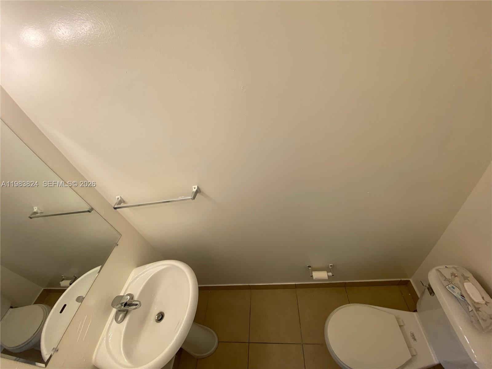 928 Southwest 3rd Street, Unit 203 Miami, FL 33130 - Photo 9 of 11 a bathroom with a toilet and a sink