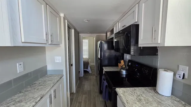 a kitchen with a refrigerator sink and stove