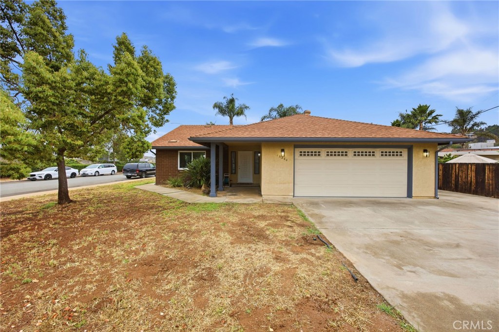 13240 Olive Tree Lane Poway, CA 92064 - Photo 2 of 50 a front view of a house with a yard