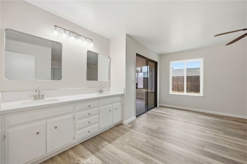 13240 Olive Tree Lane Poway, CA 92064 - Photo 26 of 50 a spacious bathroom with double vanity a mirror and a bathtub