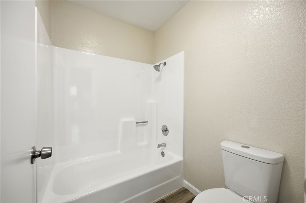 13240 Olive Tree Lane Poway, CA 92064 - Photo 28 of 50 a bathroom with a toilet and a bathtub