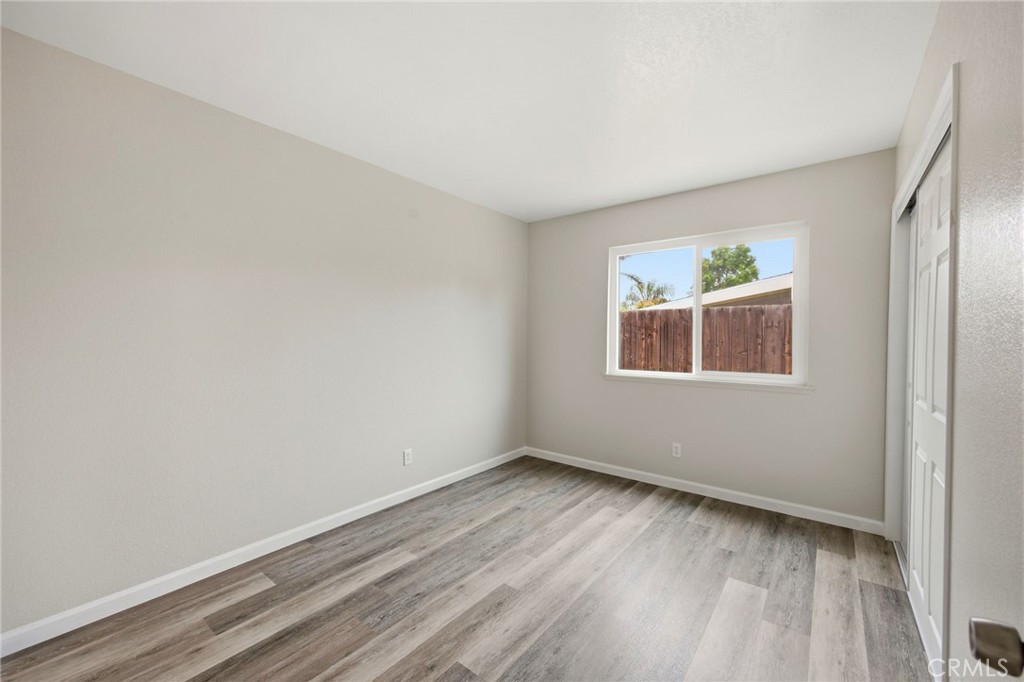 13240 Olive Tree Lane Poway, CA 92064 - Photo 32 of 50 a view of an empty room with wooden floor and a window