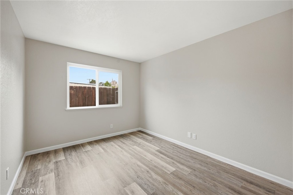 13240 Olive Tree Lane Poway, CA 92064 - Photo 34 of 50 a view of an empty room with wooden floor and a window