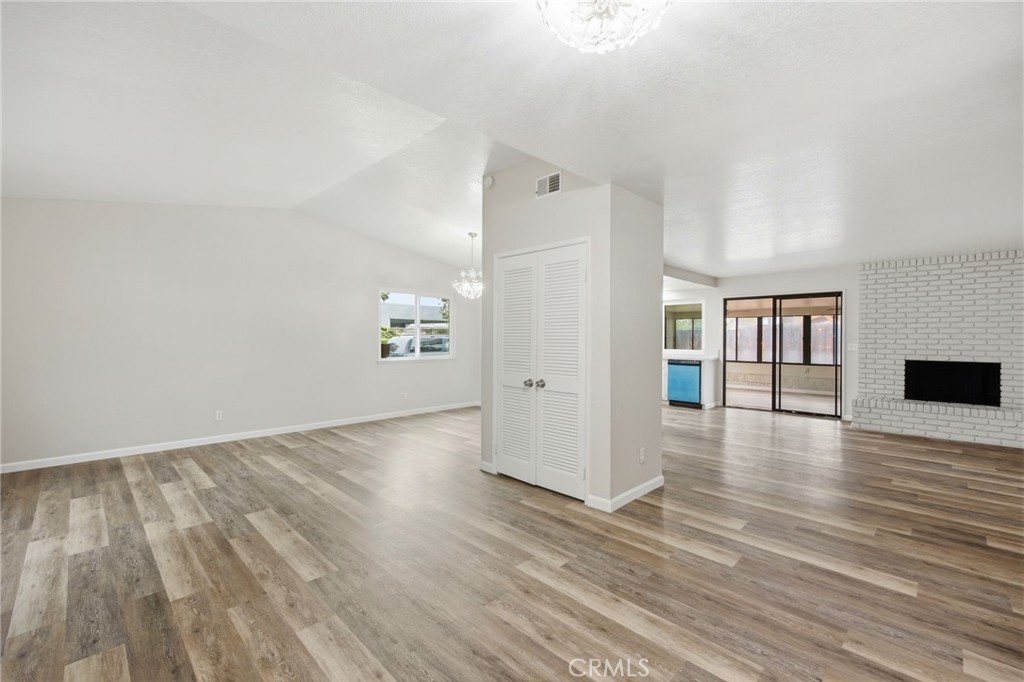 13240 Olive Tree Lane Poway, CA 92064 - Photo 10 of 50 a view of empty room with wooden floor and fireplace