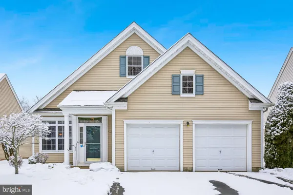 a kitchen with stainless steel appliances a stove a sink dishwasher a refrigerator with a dining table and chairs with wooden floor