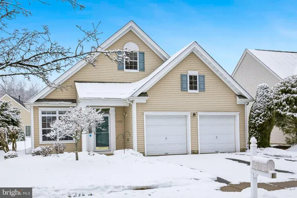 a view of a house with a yard covered with snow in front of house