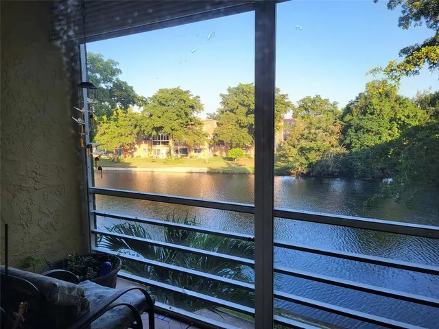 a view of a glass door with a lake view