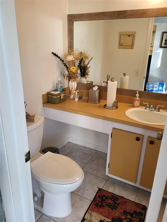 9070 Lime Bay Boulevard, Unit 309 Tamarac, FL 33321 - Photo 11 of 16 a bathroom with a sink and a mirror