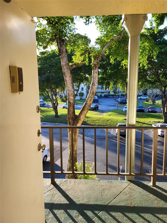 9070 Lime Bay Boulevard, Unit 309 Tamarac, FL 33321 - Photo 12 of 16 a front view of a house with a yard