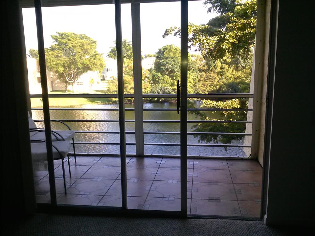 9070 Lime Bay Boulevard, Unit 309 Tamarac, FL 33321 - Photo 13 of 16 a view of a glass door with a balcony from a room