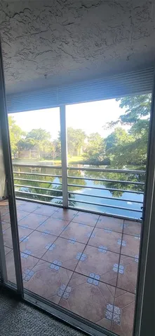 a view of an empty room with a floor to ceiling window