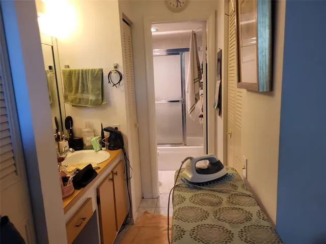 a bedroom with a bed and a potted plant