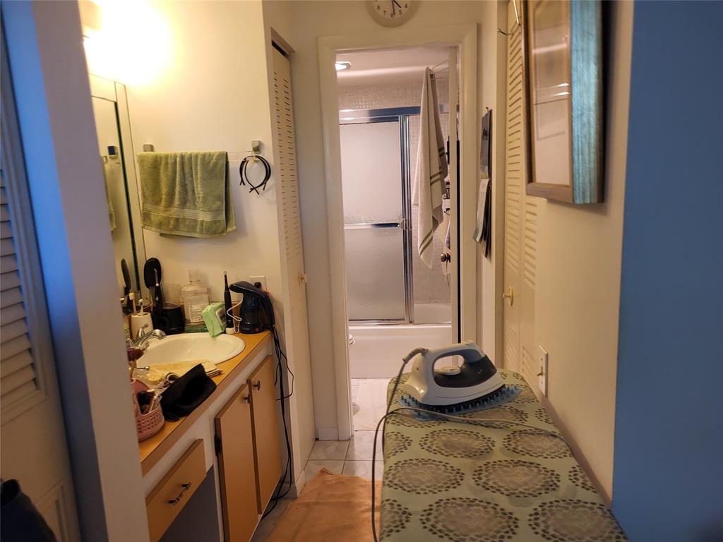 9070 Lime Bay Boulevard, Unit 309 Tamarac, FL 33321 - Photo 7 of 16 a bedroom with a bed and a potted plant