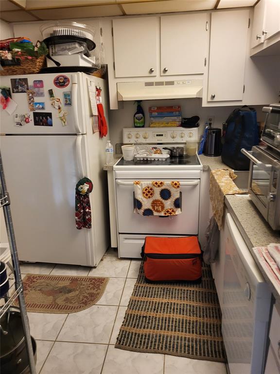 9070 Lime Bay Boulevard, Unit 309 Tamarac, FL 33321 - Photo 8 of 16 a kitchen with a refrigerator and a stove