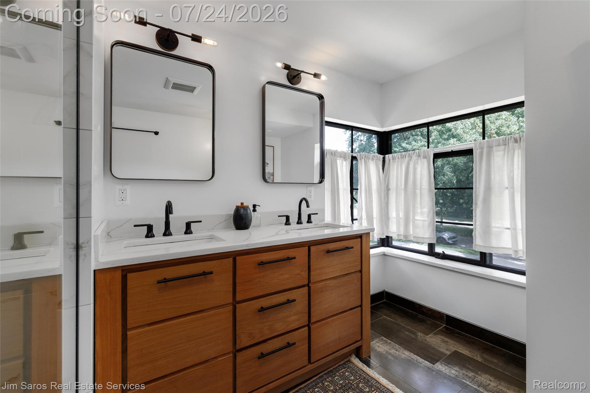 757 Middlesex Road Grosse Pointe, MI 48230 - Photo 27 of 45 Dual sink vanity featuring a light wood-finish base, white countertop, and matte black fixtures