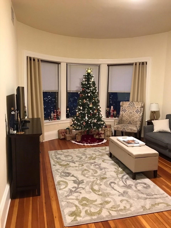 1463 Beacon Street, Unit 32 Brookline, MA 02446 - Photo 1 of 10 a living room with furniture and a fireplace