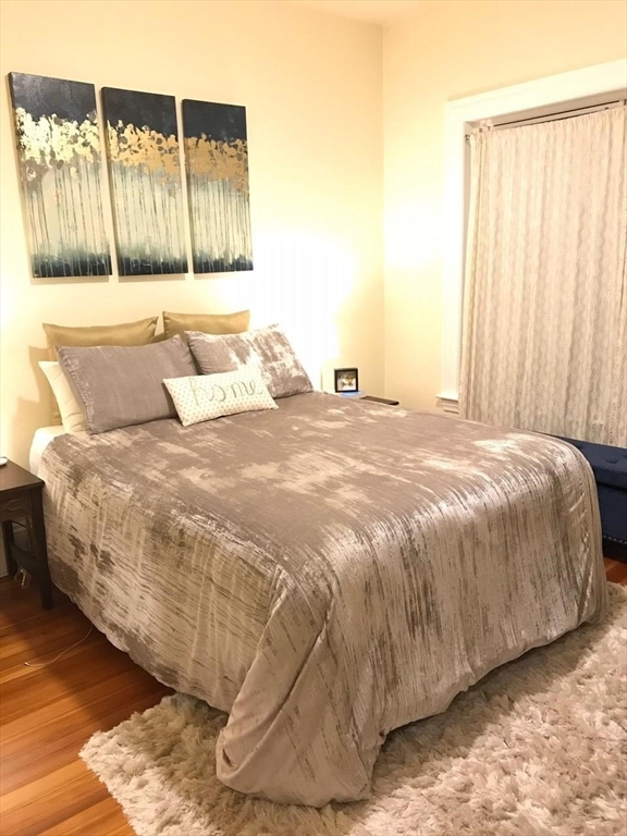 1463 Beacon Street, Unit 32 Brookline, MA 02446 - Photo 6 of 10 a bedroom with a bed and a window