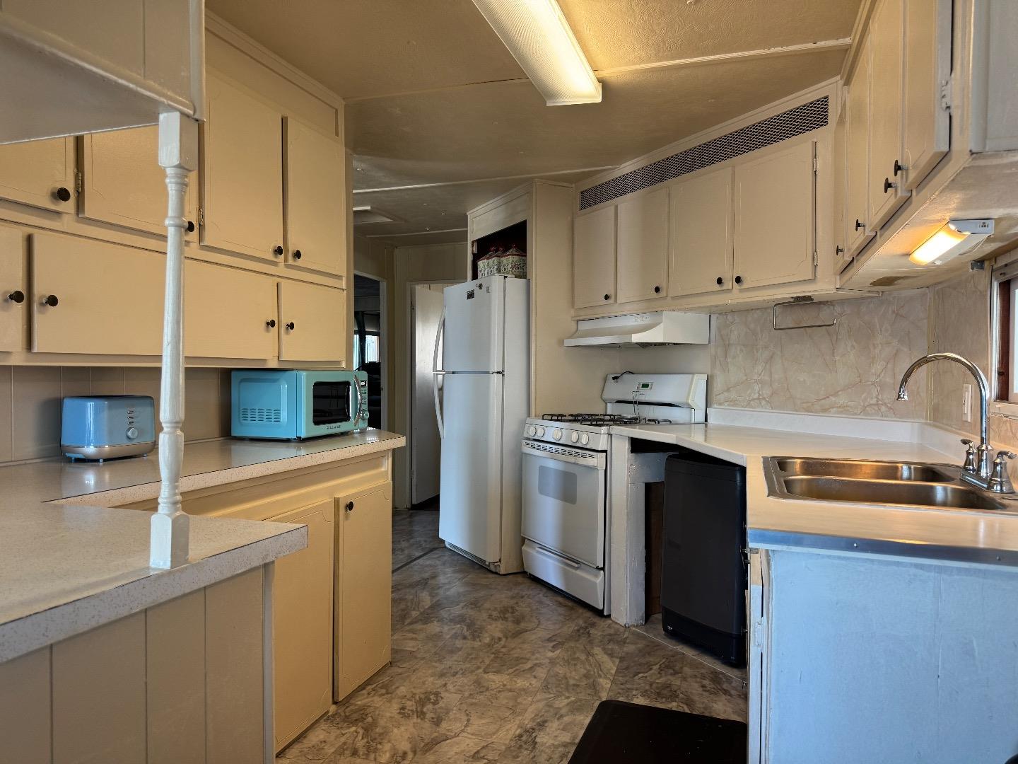 55 San Juan Grade Road, Unit 79 Salinas, CA 93906 - Photo 4 of 22 a kitchen with stainless steel appliances a refrigerator sink and cabinets