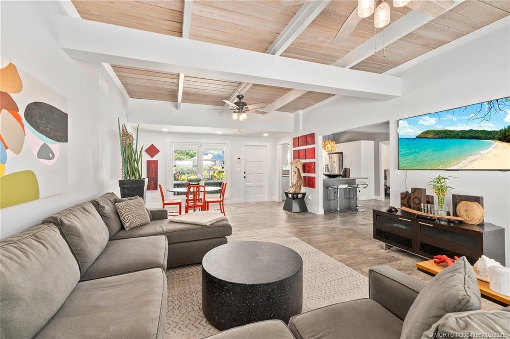 530 South Manor Drive Stuart, FL 34994 - Photo 13 of 55 a living room with furniture and a large window