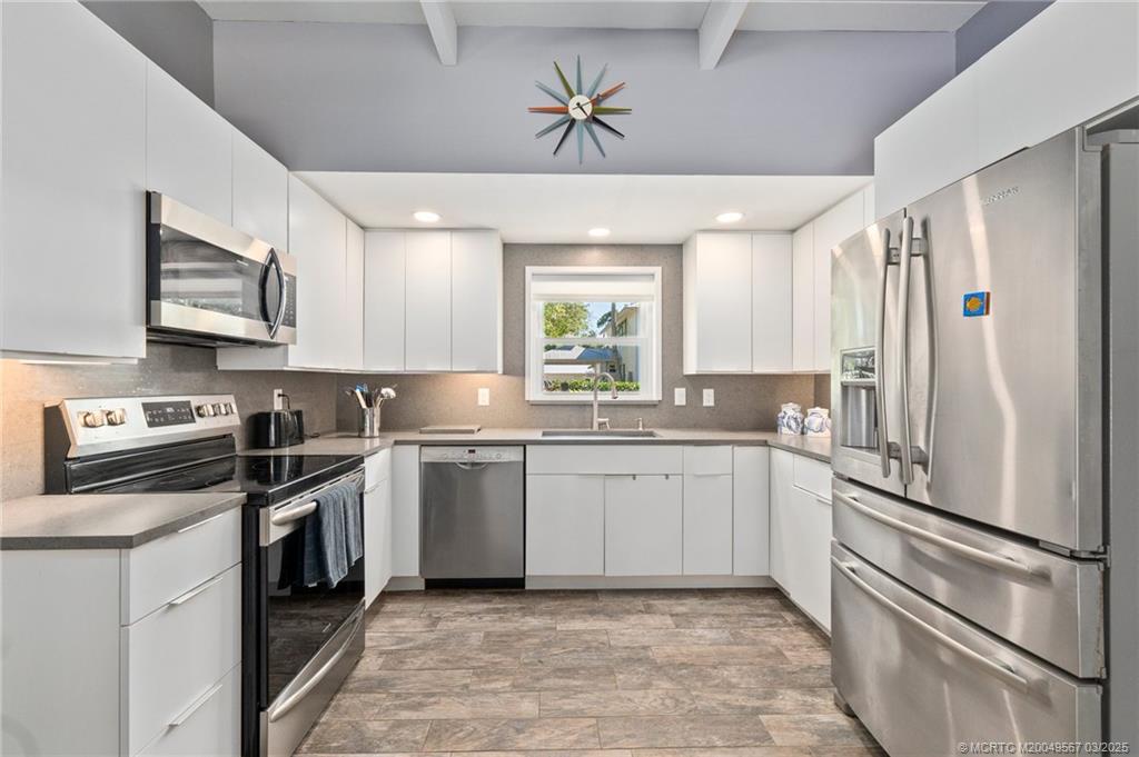 530 South Manor Drive Stuart, FL 34994 - Photo 18 of 55 a kitchen with a refrigerator stove and microwave