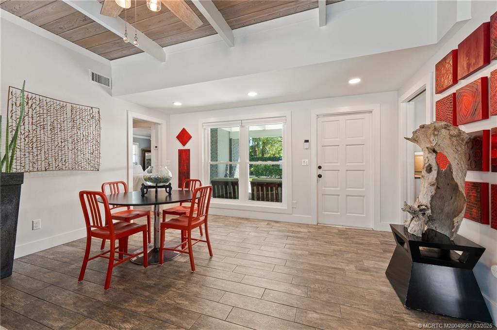 530 South Manor Drive Stuart, FL 34994 - Photo 22 of 55 a dining room with furniture and wooden floor