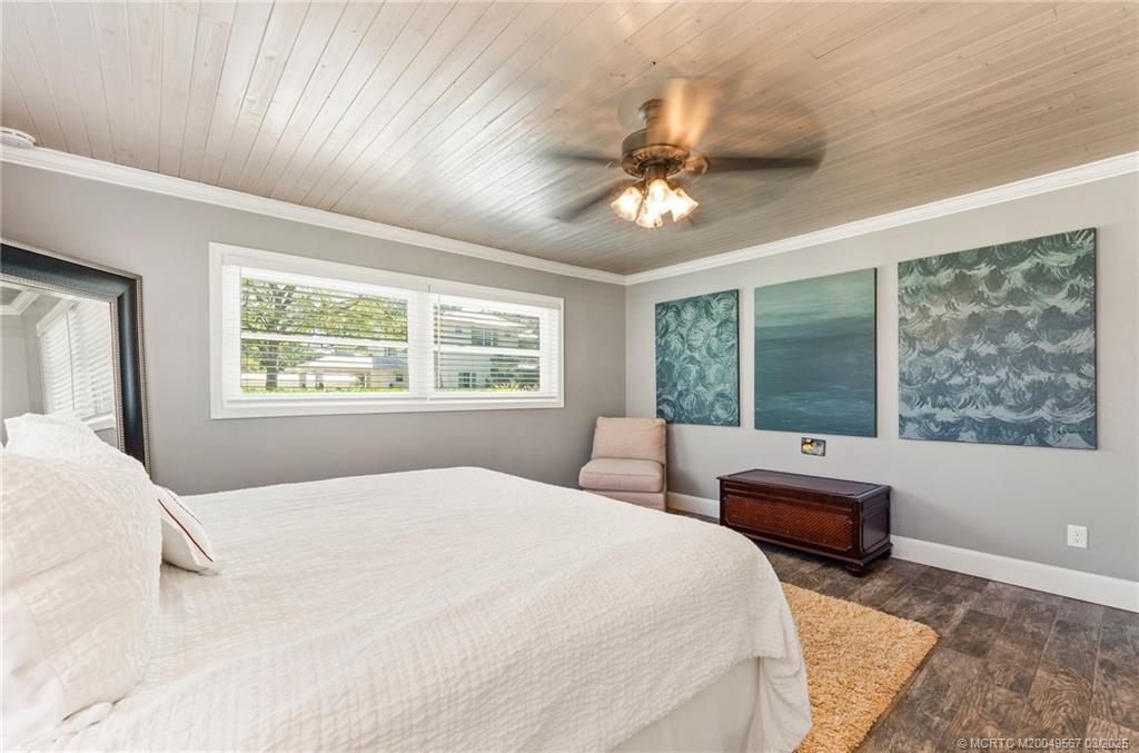 530 South Manor Drive Stuart, FL 34994 - Photo 23 of 55 a bedroom with a large bed and a large window