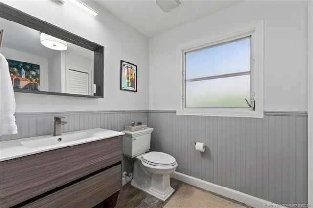 a view of a livingroom with wooden floor and a hallway