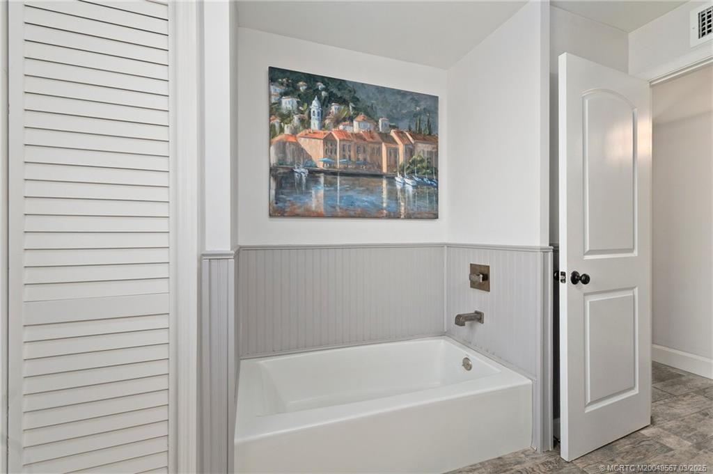 530 South Manor Drive Stuart, FL 34994 - Photo 29 of 55 a bathroom with a bathtub and shower