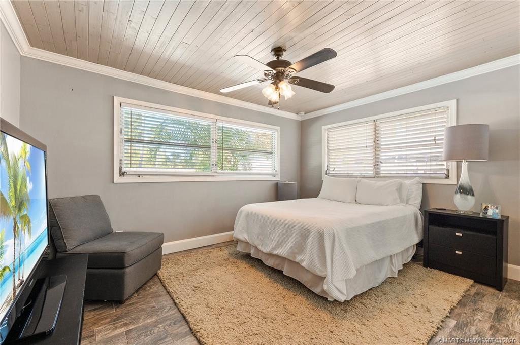 530 South Manor Drive Stuart, FL 34994 - Photo 30 of 55 a bedroom with a bed and wooden floor