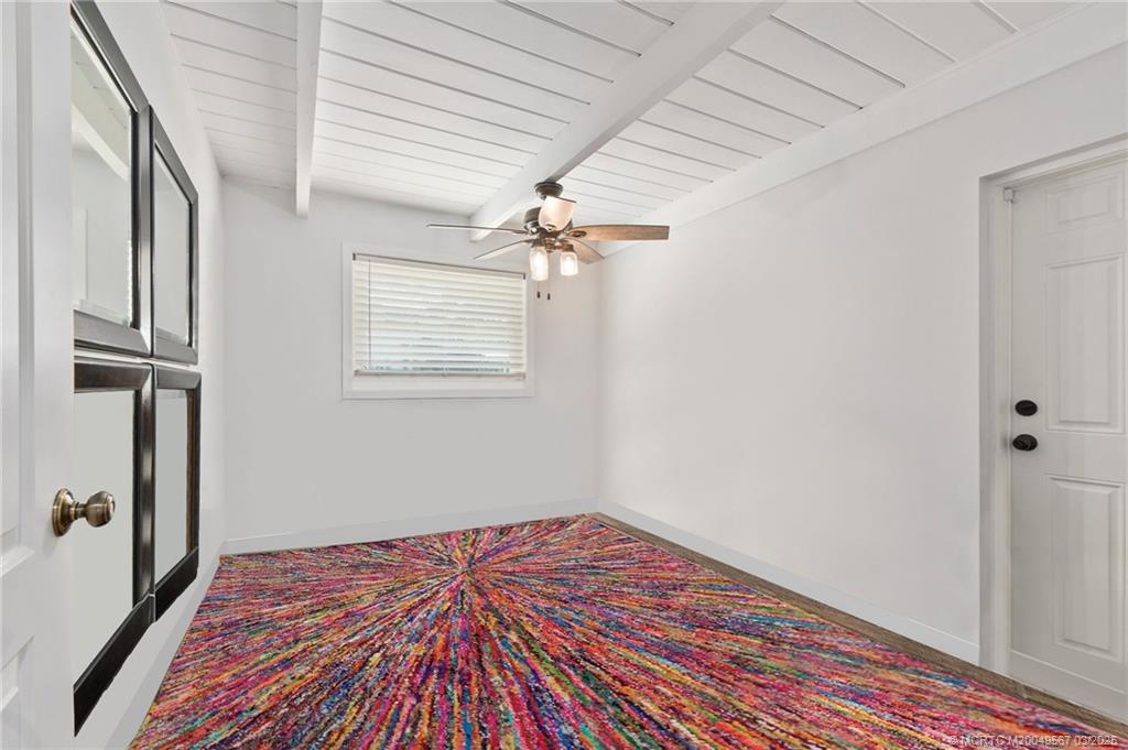 530 South Manor Drive Stuart, FL 34994 - Photo 31 of 55 a view of a livingroom with wooden floor and a hallway