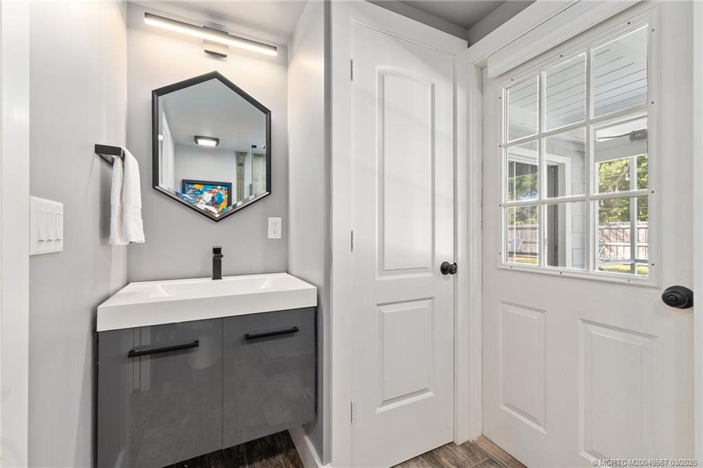 530 South Manor Drive Stuart, FL 34994 - Photo 33 of 55 a bathroom with a sink and a mirror