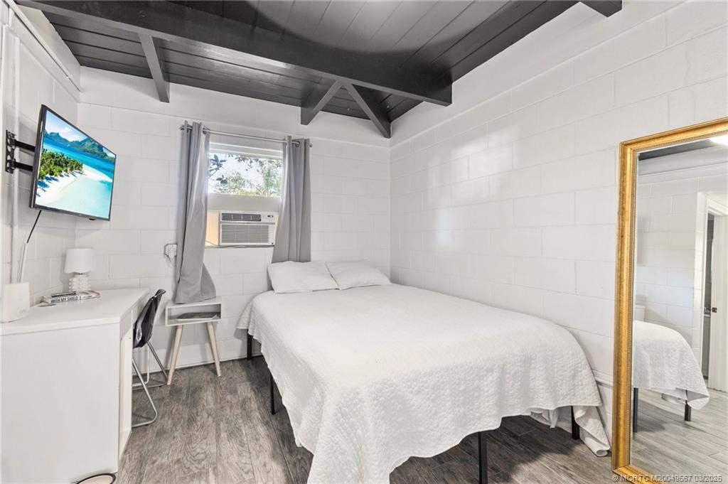 530 South Manor Drive Stuart, FL 34994 - Photo 40 of 55 a bedroom with a bed and a desk