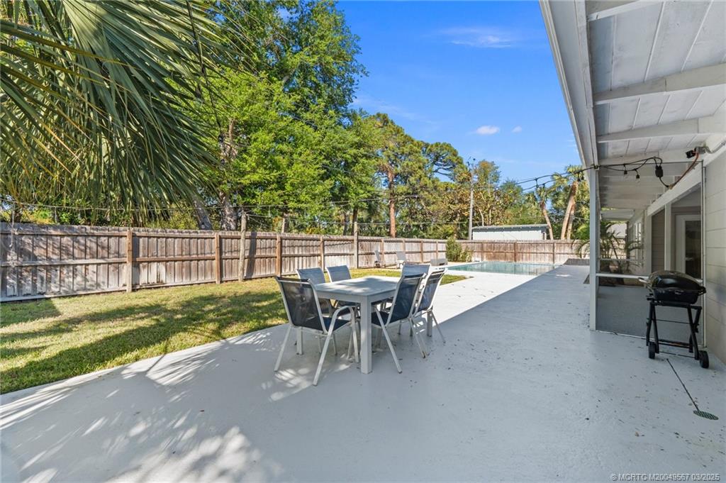 530 South Manor Drive Stuart, FL 34994 - Photo 48 of 55 a view of a patio with table and chairs and potted plants