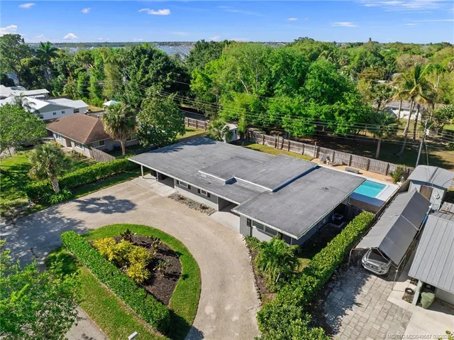 an aerial view of a building with outdoor space and lake view