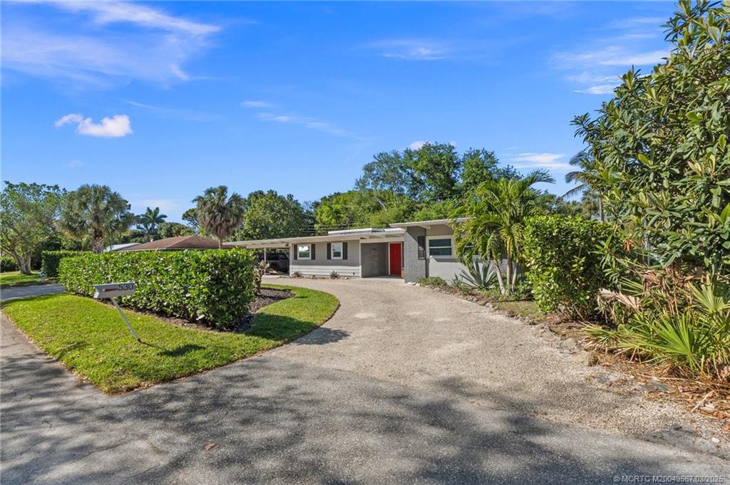 530 South Manor Drive Stuart, FL 34994 - Photo 6 of 55 a front view of a house with a yard