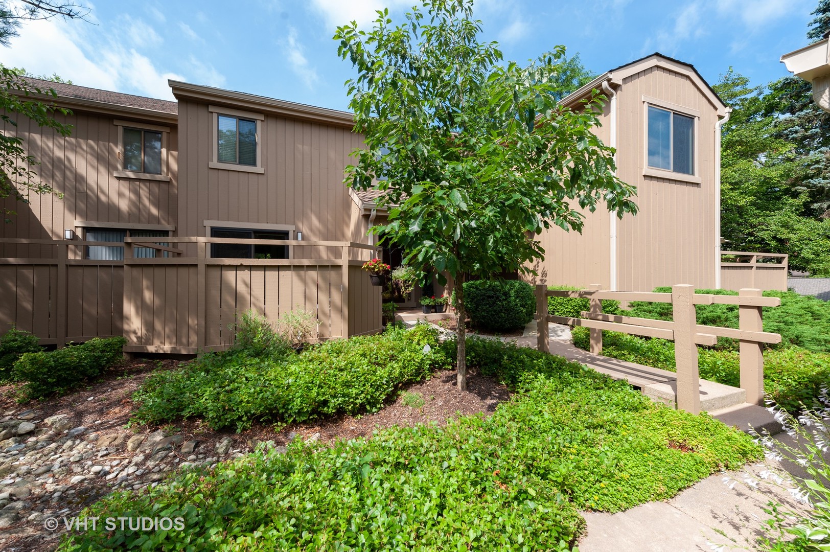 801 Oak Hill Road, Unit 471 Lake Barrington, IL 60010 - Photo 1 of 14 a front view of a house with a yard and potted plants