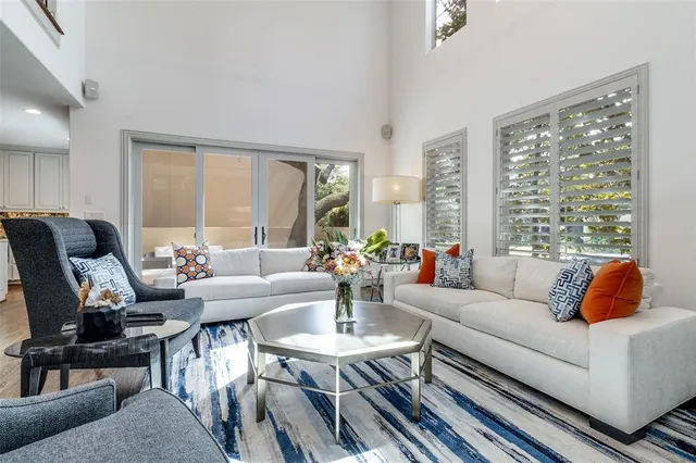 a living room with furniture and floor to ceiling windows
