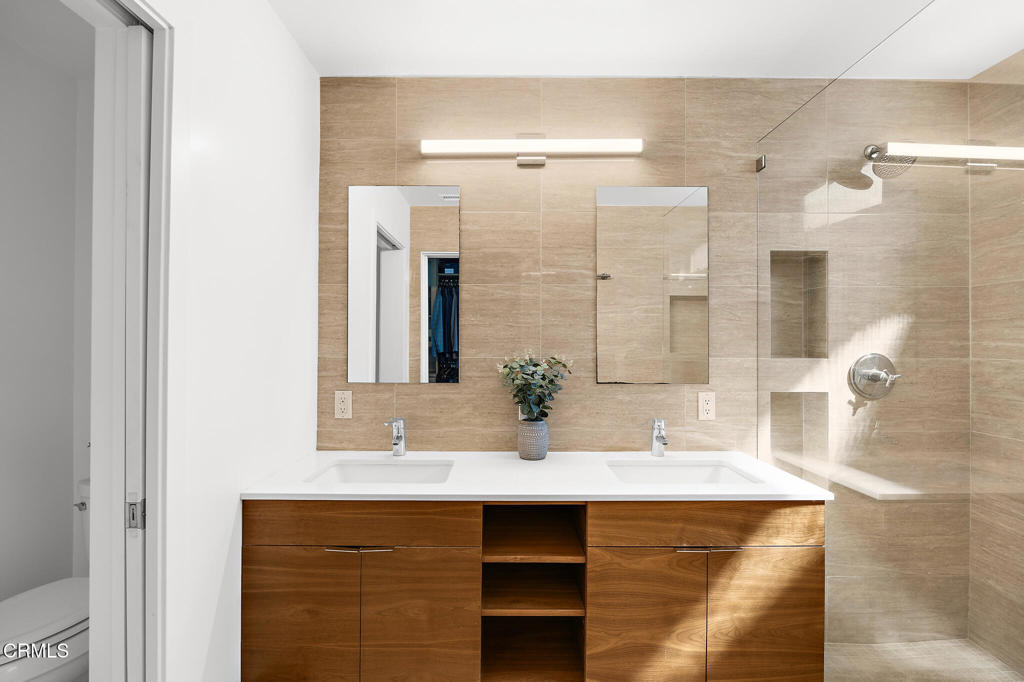 1881 Tulane Avenue Long Beach, CA 90815 - Photo 29 of 51 a bathroom with a granite countertop sink a mirror and shower